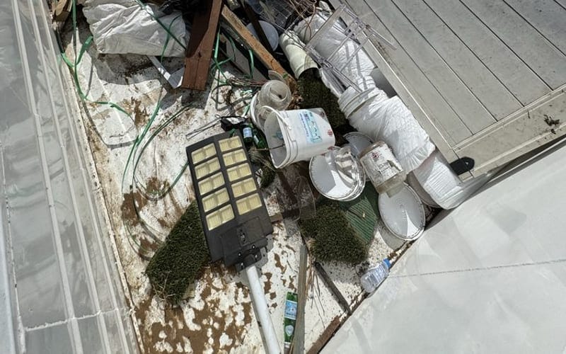 Truck bed loaded with bagged waste, piping and oversized items from a Largo job