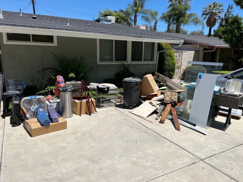 Trash cans, cardboard and old furniture cleared from the driveway of a Largo, FL house