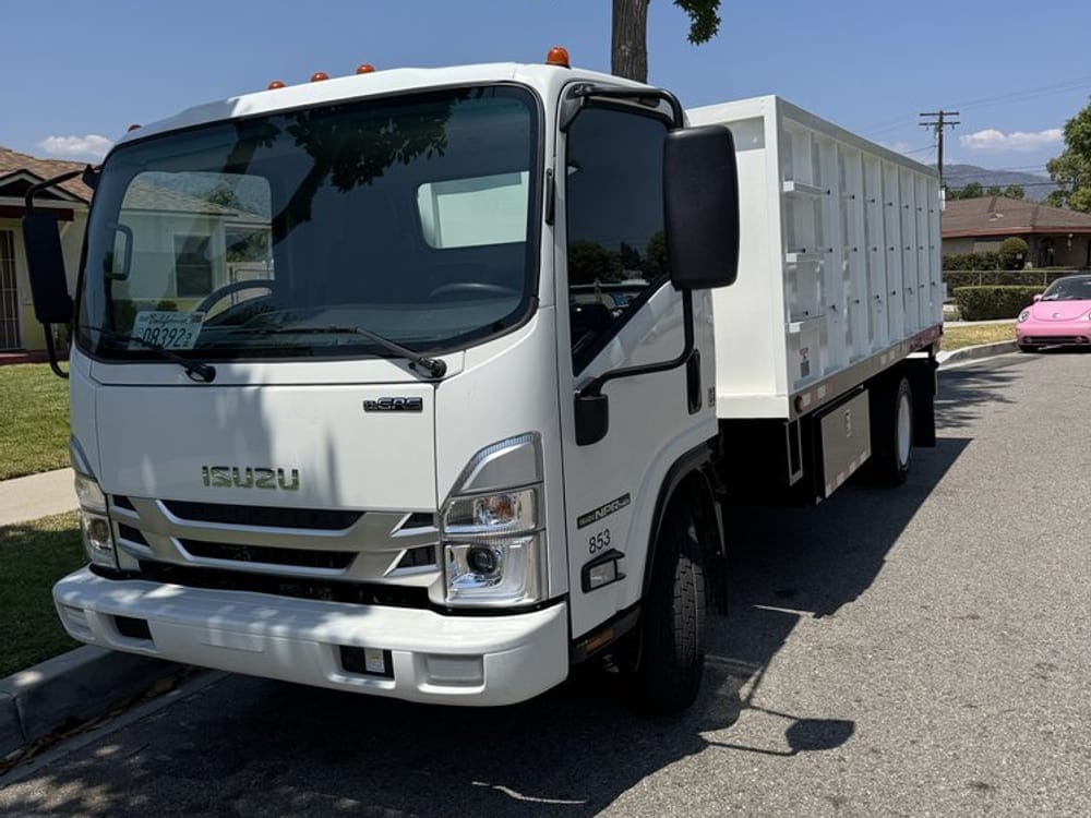 JR Largo junk hauling truck parked at the curb outside a Largo, FL job