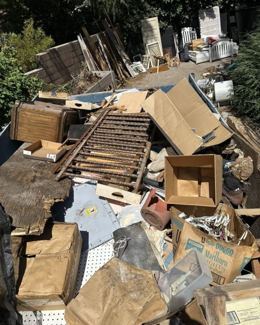 Cardboard, scrap timber and mixed household junk stacked and ready for pickup in Largo, FL