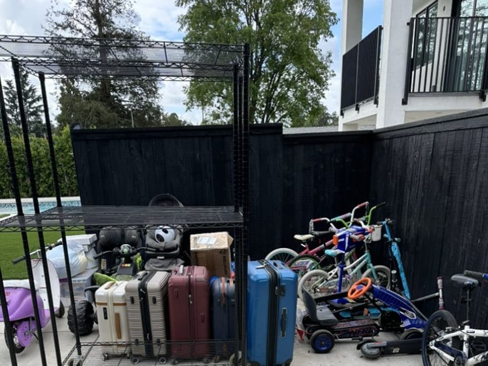 Storage racks, suitcases and bikes cleared from a carport at a Largo 55+ community