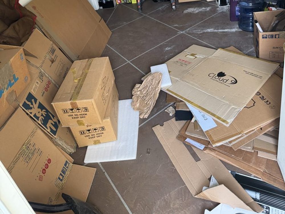 Cardboard boxes and a step ladder left behind in an office cleanout in Largo, FL