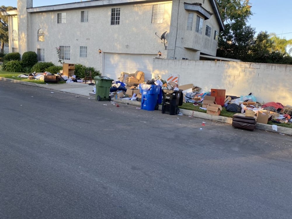 Bulk waste and bins set out at the curb of a managed apartment property in Largo, FL