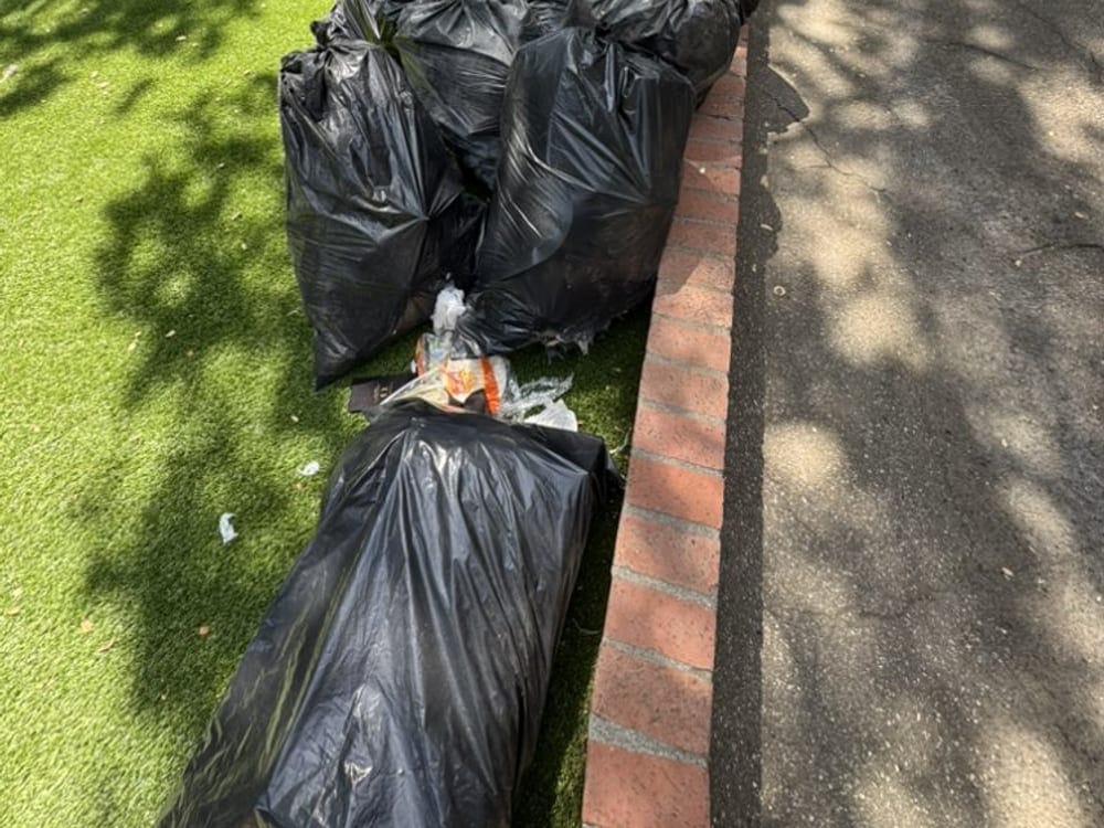 Bagged waste lined up along a driveway after a rental turnover in Largo, FL