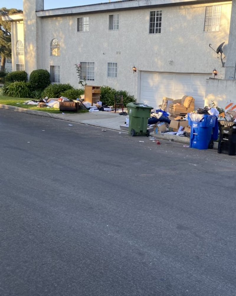 Bulk waste and wheelie bins set out at an apartment curb in Largo, FL
