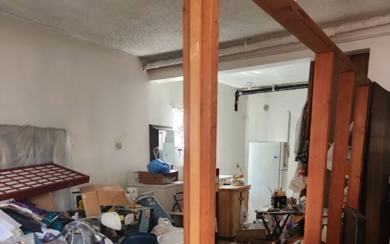 Cluttered room being worked through during a downsizing clearance in Largo, FL