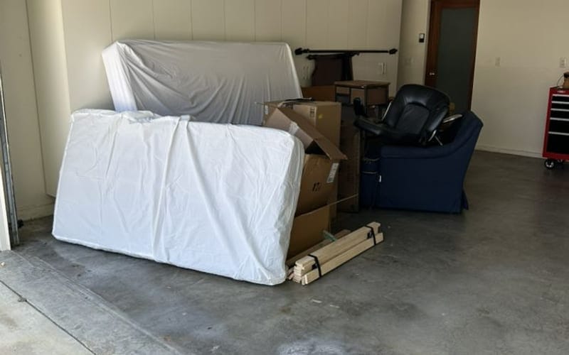 Wrapped mattress and boxes standing in an otherwise empty Largo, FL garage