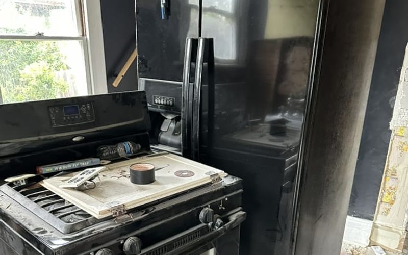 Full-size refrigerator pulled out and ready for disposal in Largo, FL